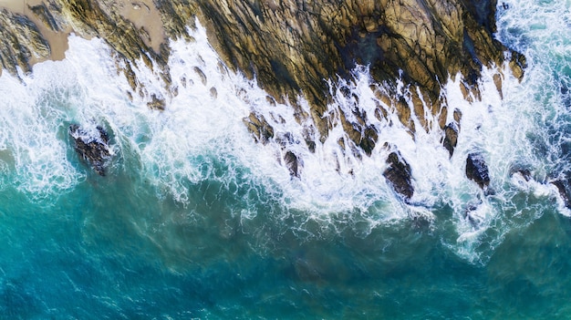 Aerial view of waves crashing on rocks,Seascape with birds eye view