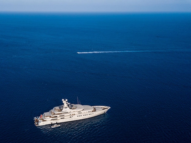 Aerial view on white yacht in blue sea