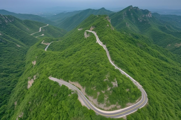 Aerial view of a winding mountain road with views of the valley below created with generative ai