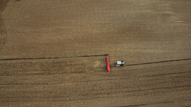 Photo aerial view with drone of tractor plowing the land in the countryside