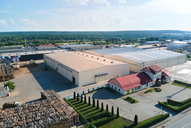 Aerial view of wood processing factory with stacks of lumber at plant manufacturing yard