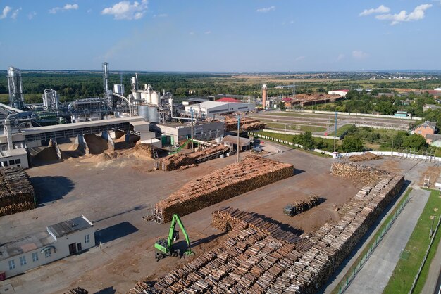 Aerial view of wood processing factory with stacks of lumber at plant manufacturing yard