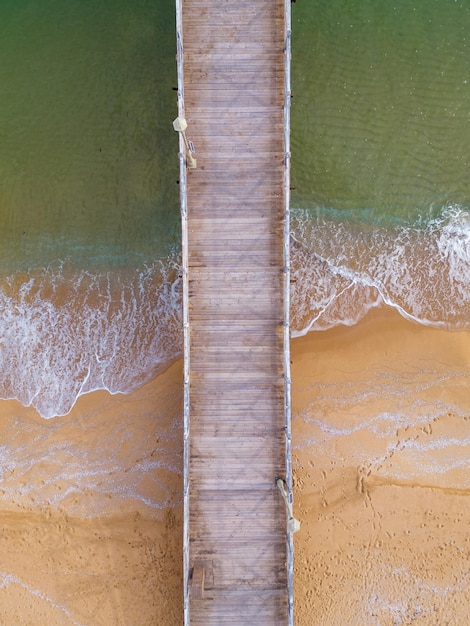 Aerial view of a wooden deserted pier in the sea