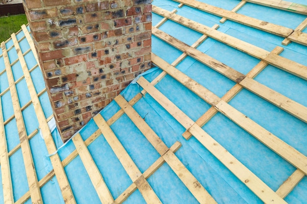 Aerial view of a wooden roof frame of brick house under construction