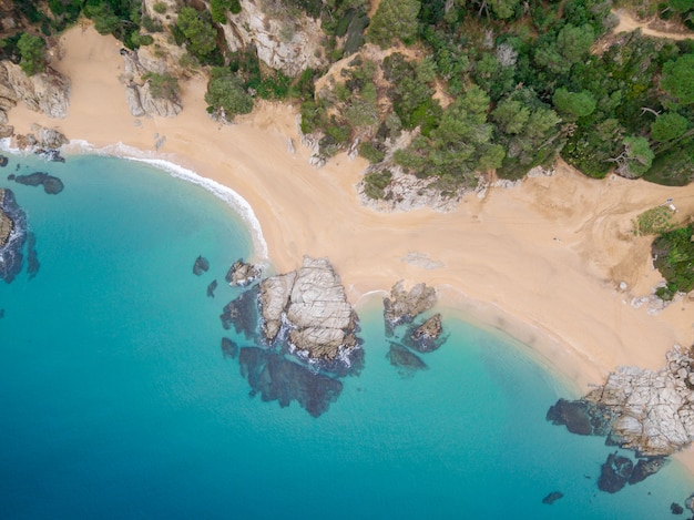 Aerial views of the rocks in the sea on a sunny day.