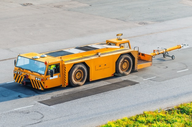 Aerodrome tow truck with trailer pusher for aircraft.