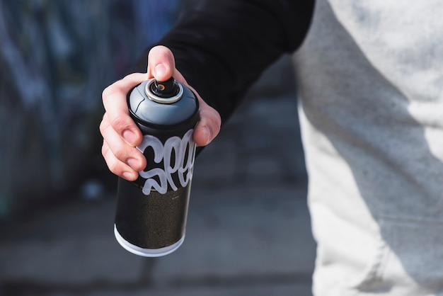 Photo aerosol spray can in human hand