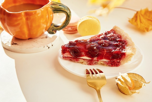 Aesthetic breakfast with cherry pie cup of tea in shape of pumpkin macaroons winter cherry Cozy home