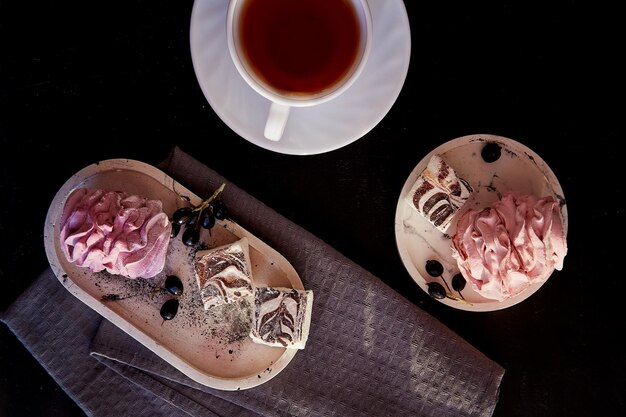 Aesthetic cozy home breakfast Cup of tea and marshmallows with currant Healthy sweets sugar and gluten free natural dessert Top view food