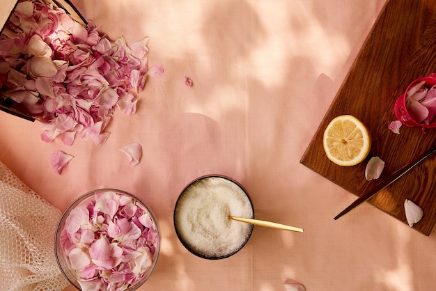 Aesthetic homemade organic rustic tea rose jam preparing with\
sugar lemon and tea rose petals healthy recipe lifestyle\
photography top view copy space