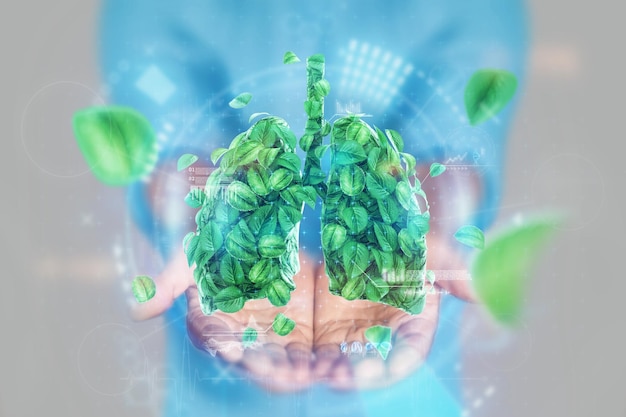 Afbeelding menselijke longen gemaakt van groene bladeren op en handen luchtvervuiling frisse adem CO2 modern design tijdschriftstijl Kopieer ruimte
