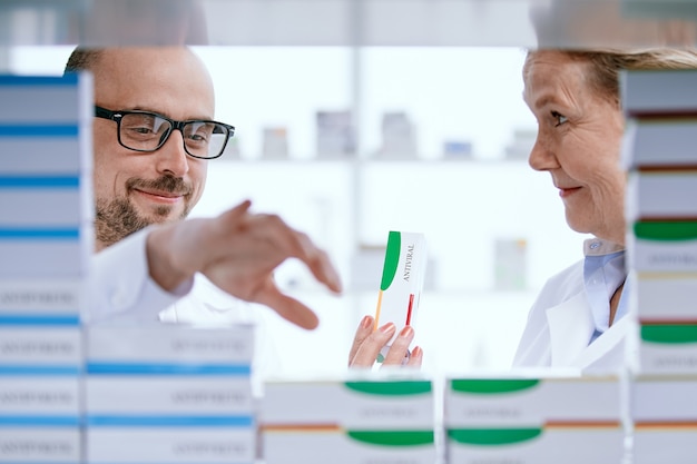 Foto afbeelding van een collega van apothekers die nieuwe medicijnen bespreekt