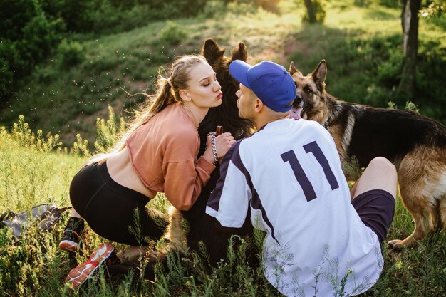 Affectionate couple with dogs outdoors