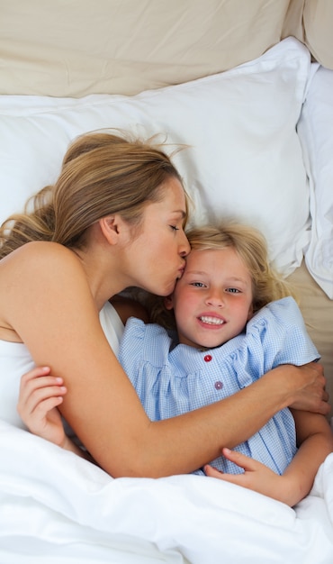 Affectionate mother kissing her daughter 