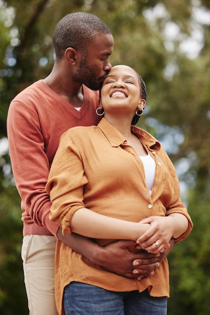 Affectionate romantic and in love couple hugging kissing and enjoying time together outdoors Man and women in a loving passionate and caring marriage having an embracing moment in nature outside