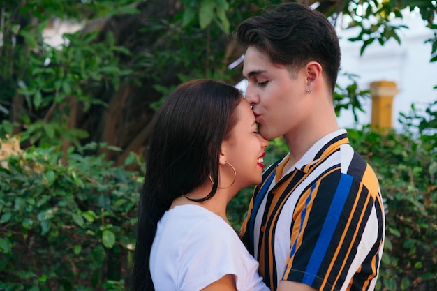 Affectionate young couple kissing at park