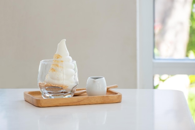 Affogato espresso on wooden disk on the white table near\
windows in coffee shop ice cream cafe copy space