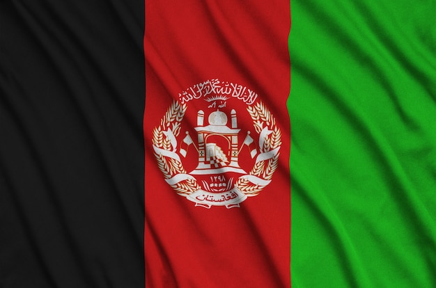 Afghanistan flag is depicted on a sports cloth fabric with many folds.