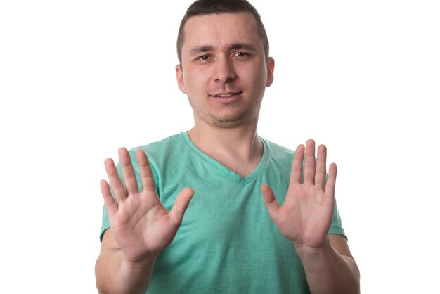 Photo afraid man in defense attitude gesturing stop with hands  isolated on white background