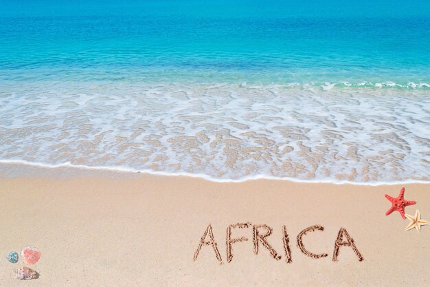 Photo africa written on a tropical beach