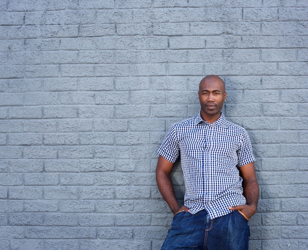 African america man standing against a gray wall  