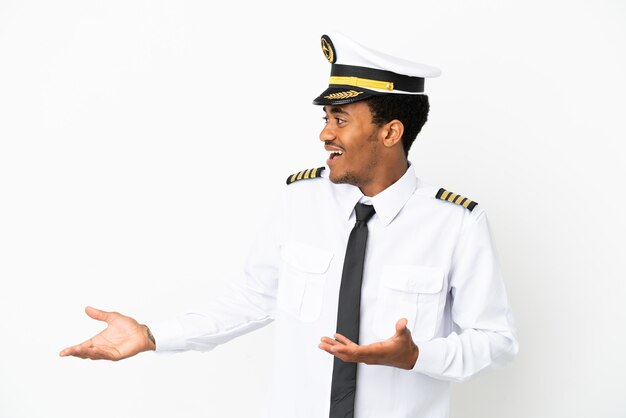 African American Airplane pilot over isolated white background with surprise facial expression