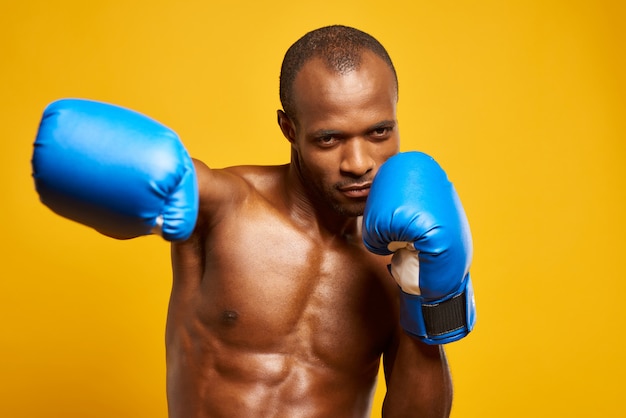African American athlete boxing in boxing gloves