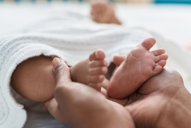 African american baby lying on bed at bedroom