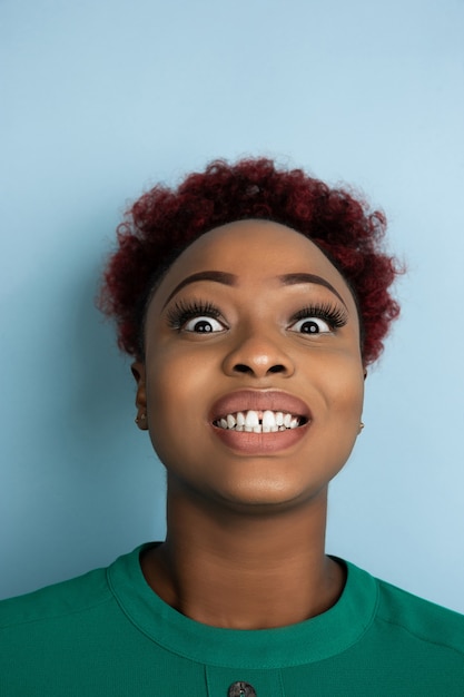 African-american beautiful woman's portrait on blue studio background