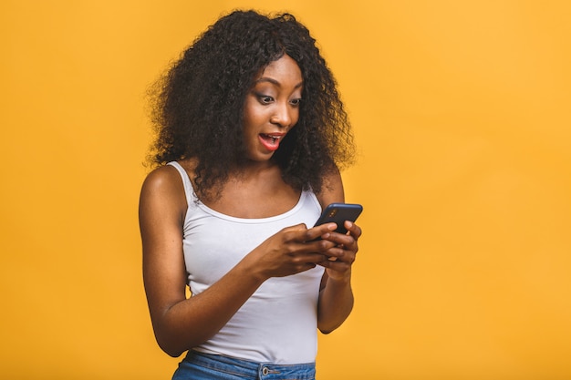 African American black girl holding in hands phone chatting on the web