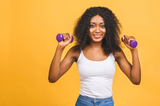 African american black young woman exercising her muscle with dumbbells