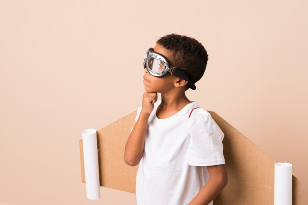 African american boy with aviator hat and with wings over\
isolated