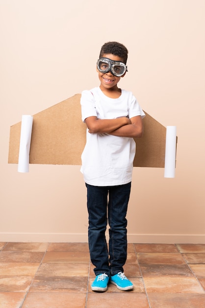 African American boy  with aviator hat and with wings