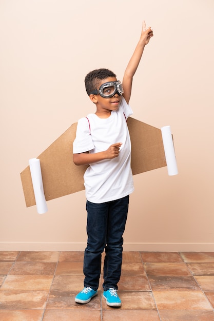 African American boy  with aviator hat and with wings