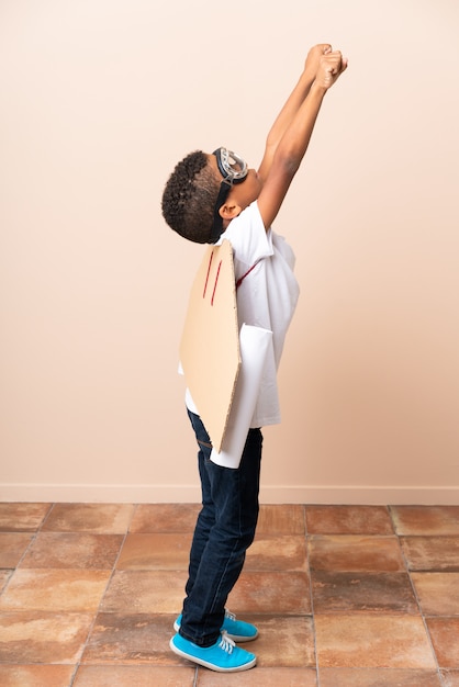 African American boy  with aviator hat and with wings