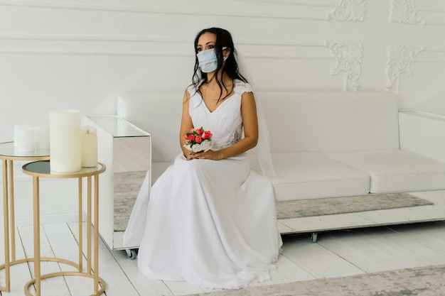 African American bride in dress, mask and in the morning preparing for the wedding in hotel room