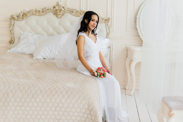 African American bride in dress in the morning preparing for the wedding in a hotel room