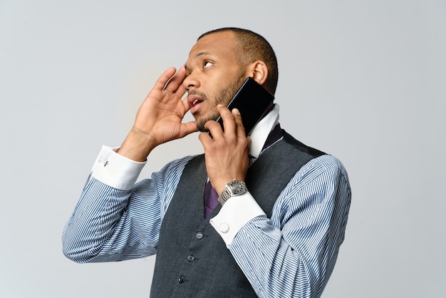 African american business man talking on mobile phone and stress and negativity