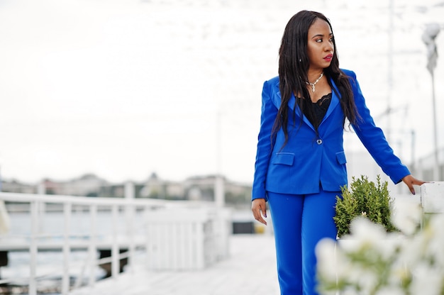 african american business woman at blue suit posed.