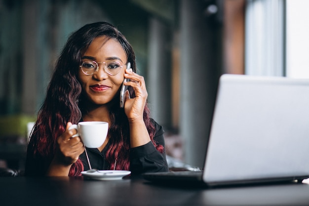 African american business woman with phone and laptop