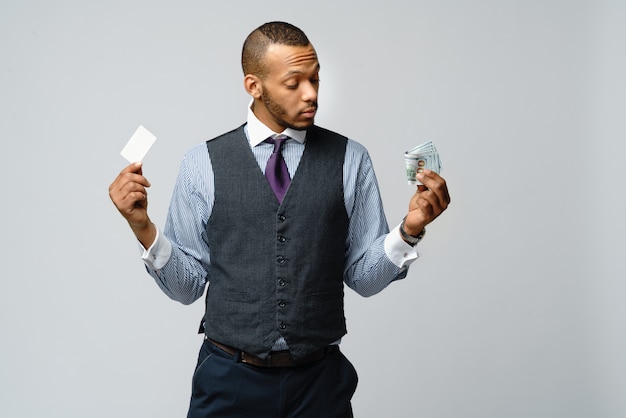 African american Businessman making choice between Credit Card and money