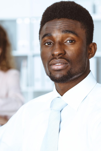 African american businessman at meeting in office, colored in white. Multi ethnic business people group.