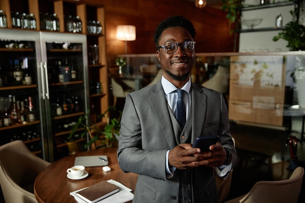 African american businessman in suit standing in cafe