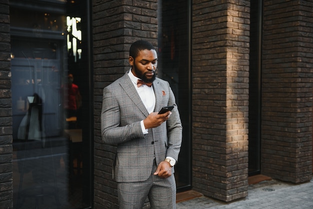 African American businessman wearing a suit standing in an outdoor business environment