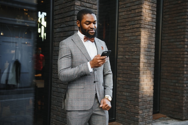 African American businessman wearing a suit standing in an outdoor business environment