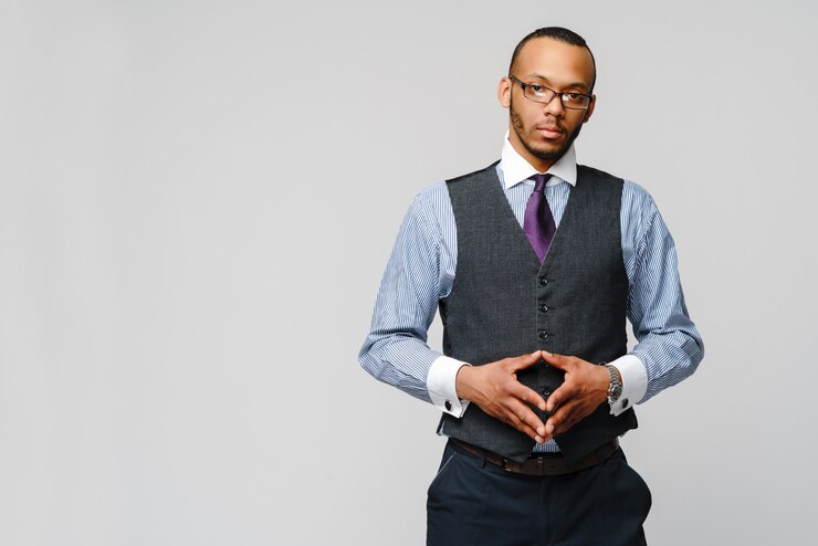 African-American businessmanman wearing glasses portrait over grey wall