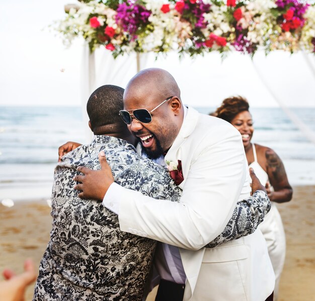 African American couple getting married at the beach