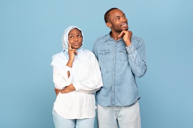 African American Couple Posing Dreaming And Thinking On Yellow Background