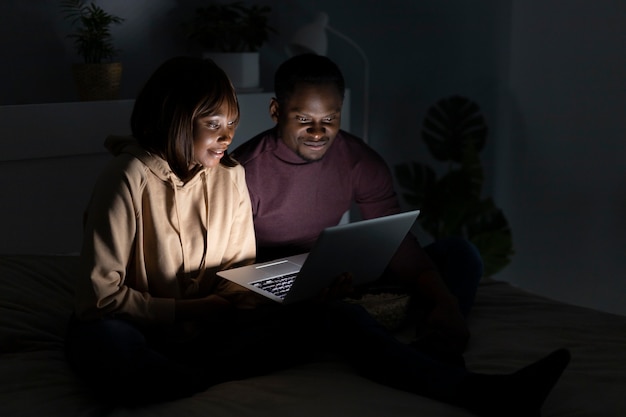 Photo african american couple watching streaming service together at home