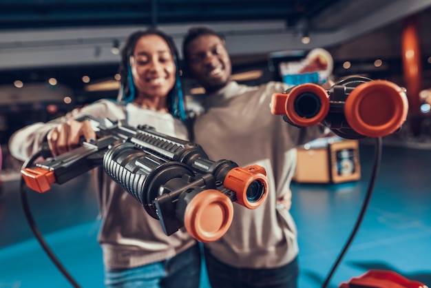 African american couple with guns in arcade.